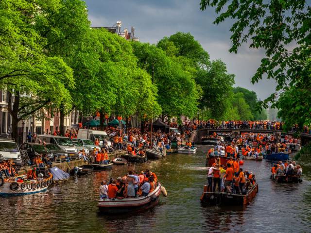 The streets of Amsterdam are filled with orange during Koninginnedag, also known as Queen's Day, when over a million people gather in the closed-off city center to party all day and night.