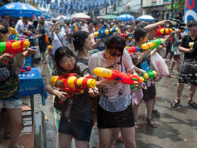 Songkran, Thailand's traditional New Year's Day, is the world's biggest water fight. Thousands gather in April to throw water from buckets, water guns, and hoses.