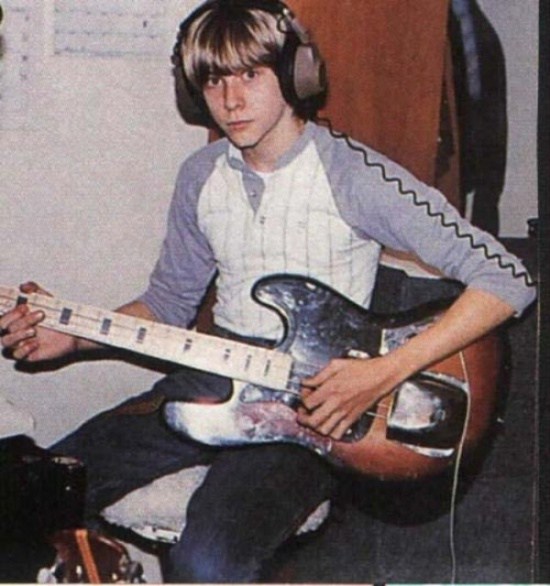 A young Kurt Cobain practicing guitar.
