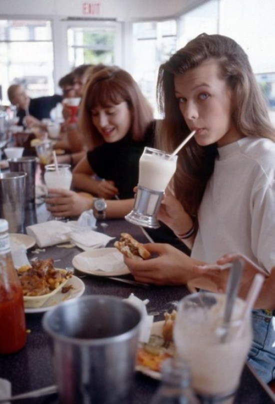 Milla Jovovich eating at a diner in the early stages of her modeling career.