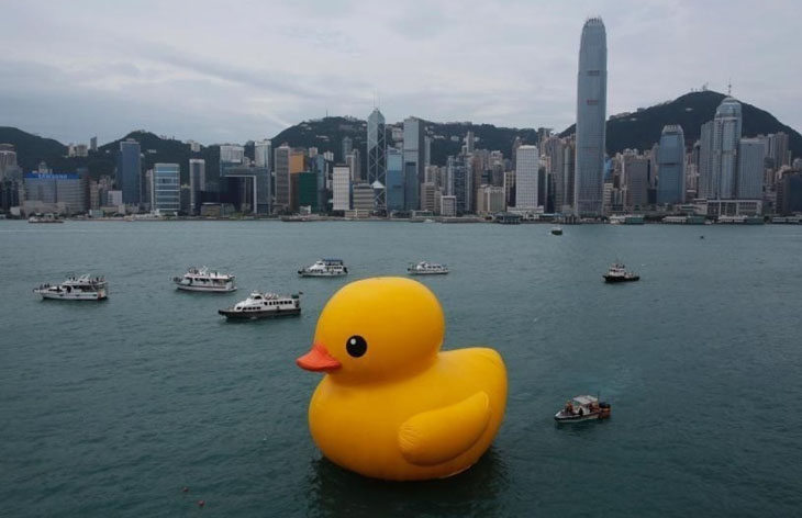 A massive rubber ducky in a city river designed by Dutch artist Florentijn Hofman.