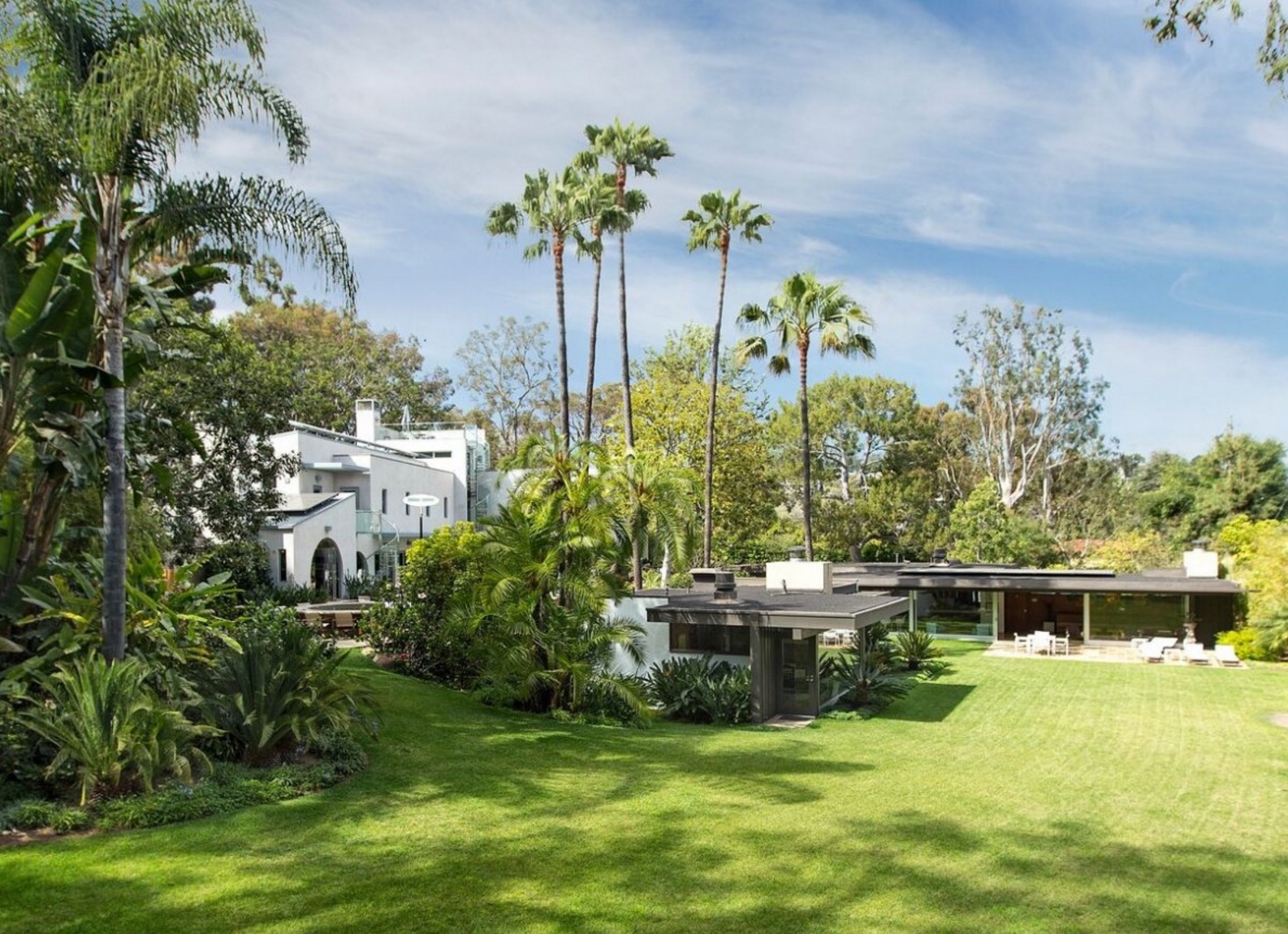 Both the home designed by Neutra, right, and the contemporary main house, right, sit in stunningly green surroundings in Pacific Palisades, California.