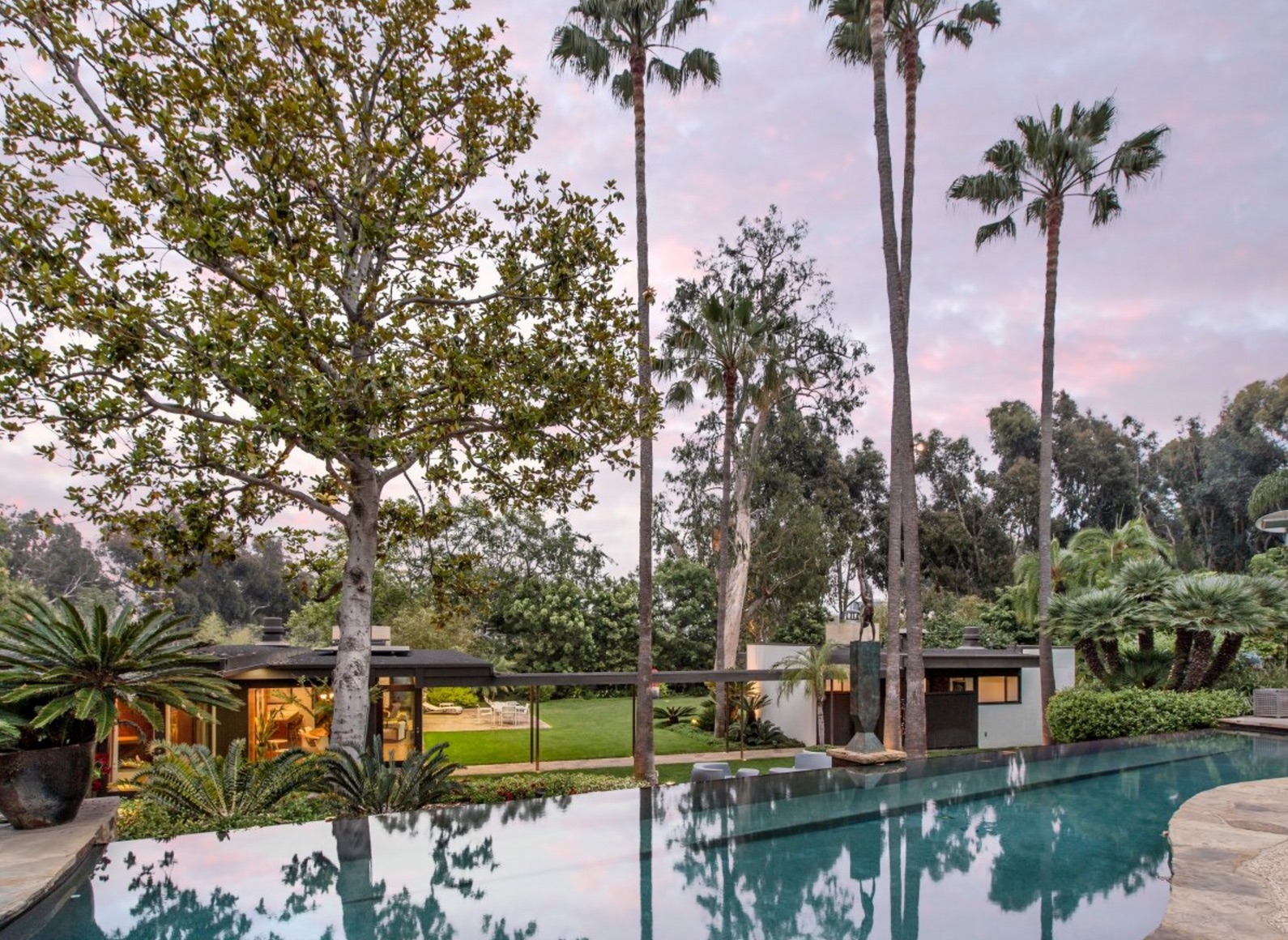 The backyard includes a beautiful cascading infinity pool. It sits between the two homes.