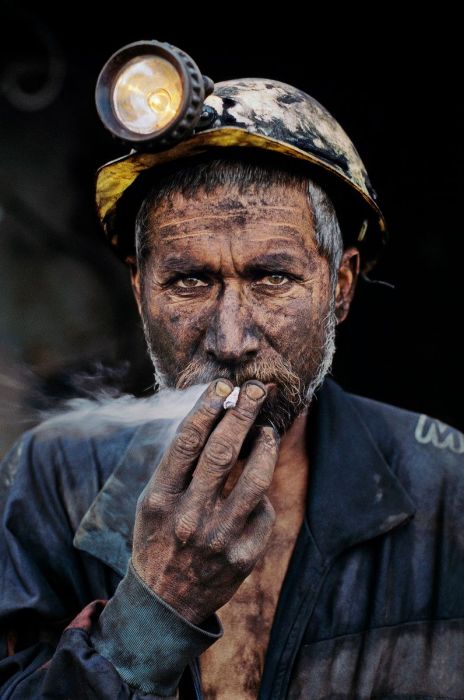 Coal miner smoking a cigarette.