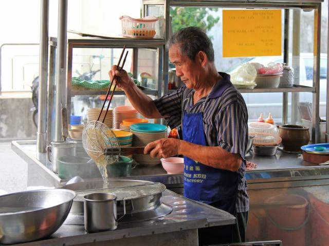 Sample street food — satay, laksa, char kueh teow, to name a few dishes — at a hawker center in Penang, Malaysia.