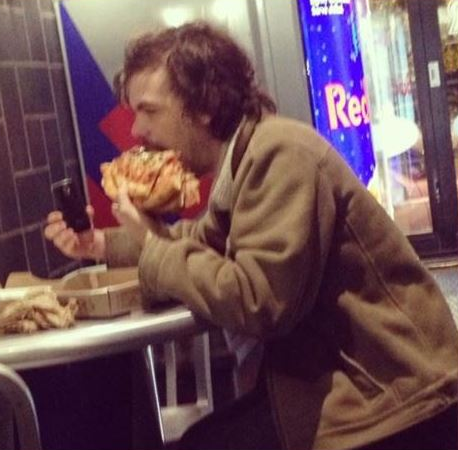 Why is he eating four slices of pizza at once?