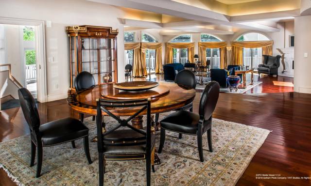 One of its living rooms features gold curtains, gold-trimmed tables, and Persian carpets.