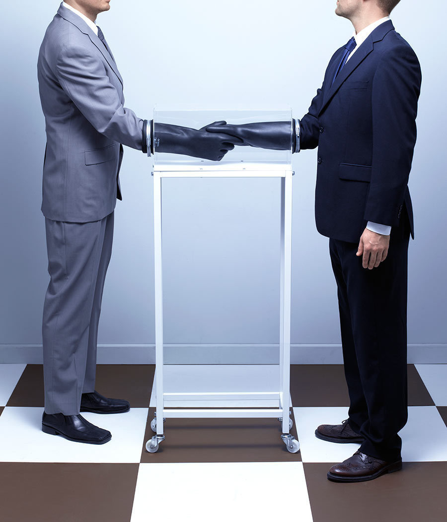 A HANDSHAKE MACHINE: A device that allows you to shake hands without contacting the skin of another person.