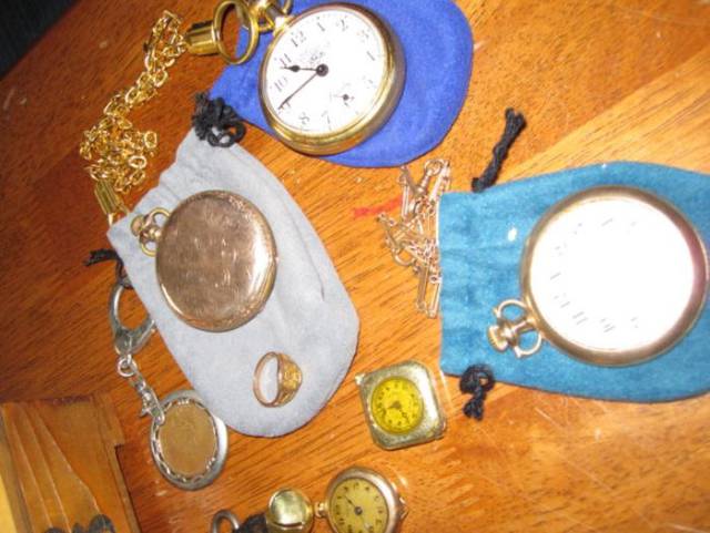 What a beautiful old collection of pocket watches, chains, and a ring.