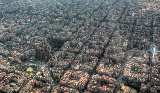 Conformity and creativity side-by-side in Barcelona. Sagrada Família stands tall to the left of the photo.