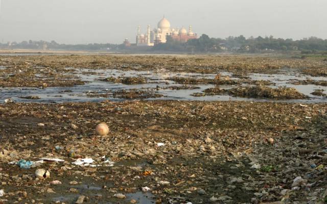 Often photographed up close in all its glory, the Taj Mahal is almost barely recognizable here.