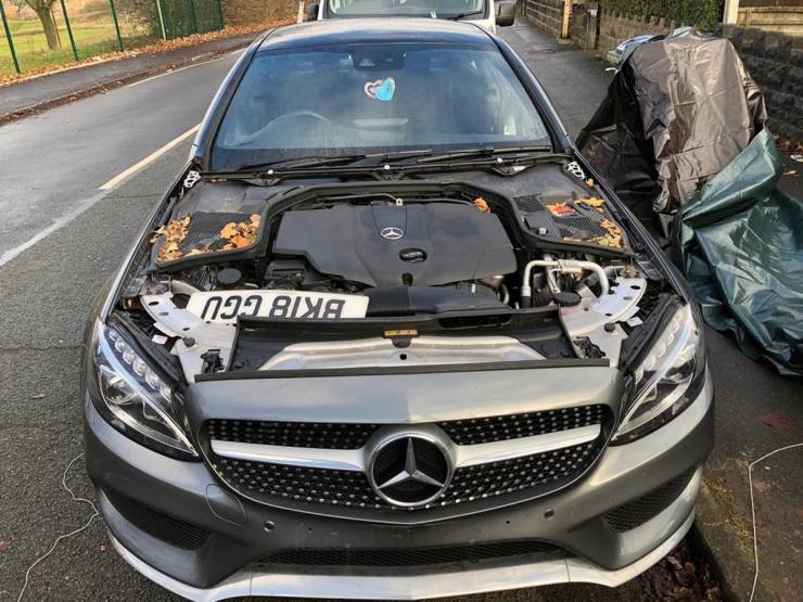 Paul Hampton's Mercedes-Benz C-Class AMG in the day time - doors taken off - tires missing - hood missing
