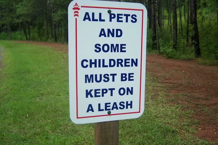 wried signs - All Pets And Some Children Must Be Kept On A Leash