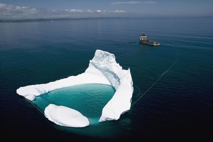 An iceberg in Newfoundland being harvested for its water.