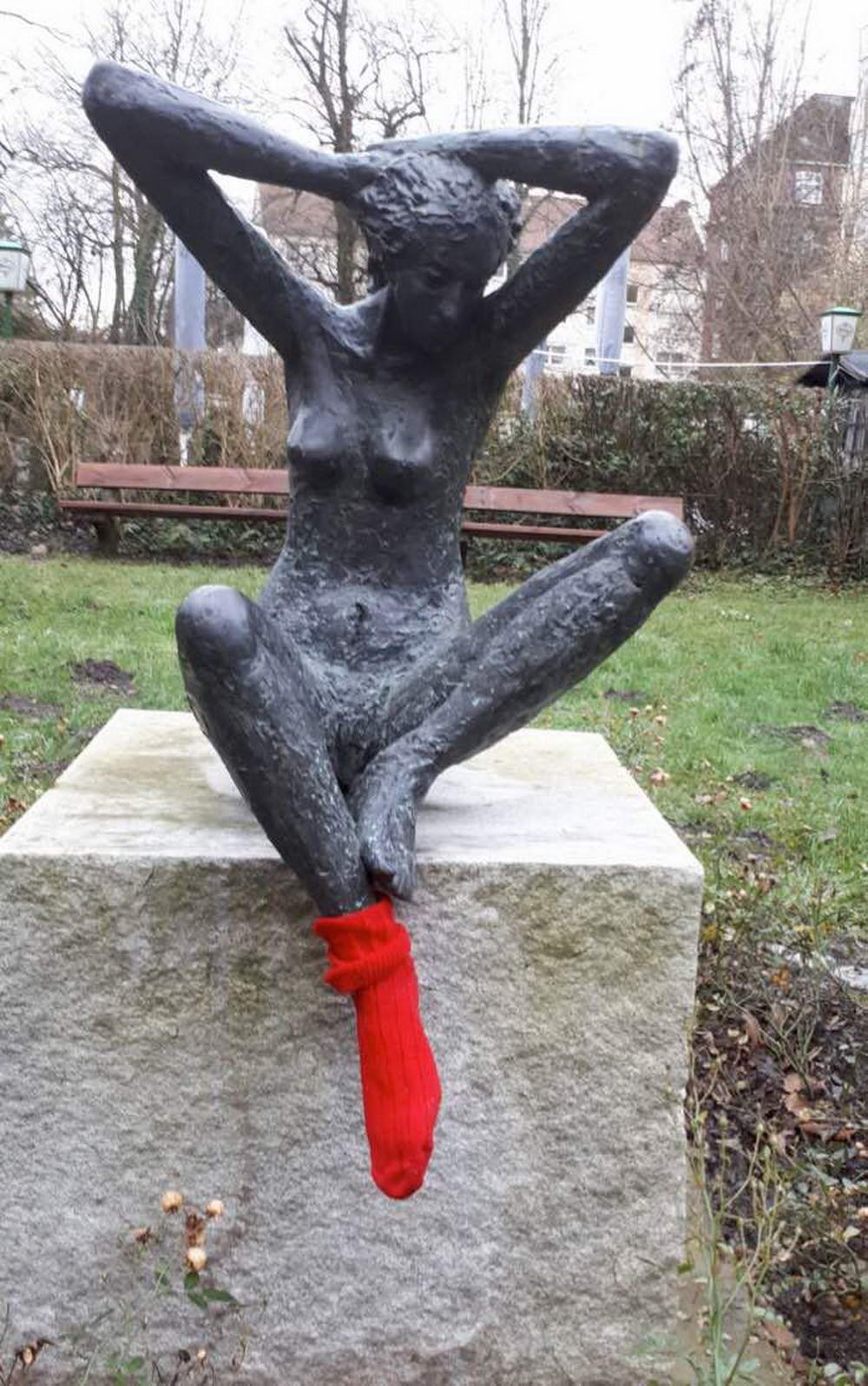 wtf images - statue wearing one red sock