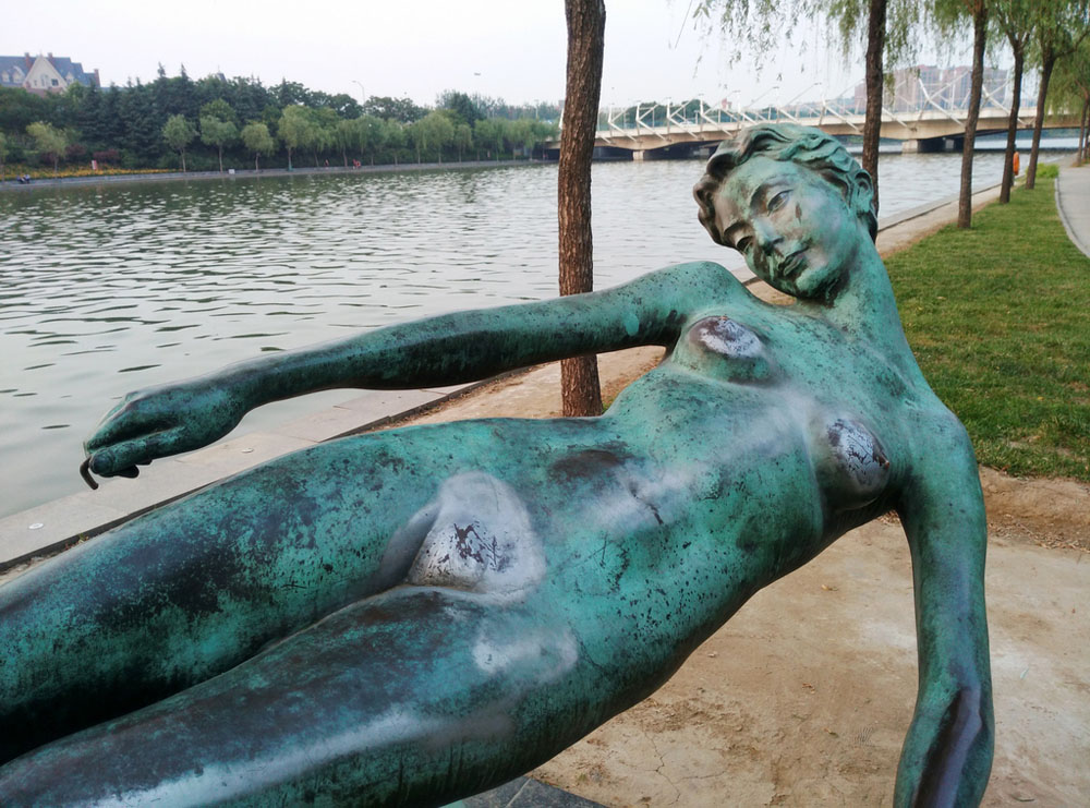 wtf images - weird woman statue next to the water