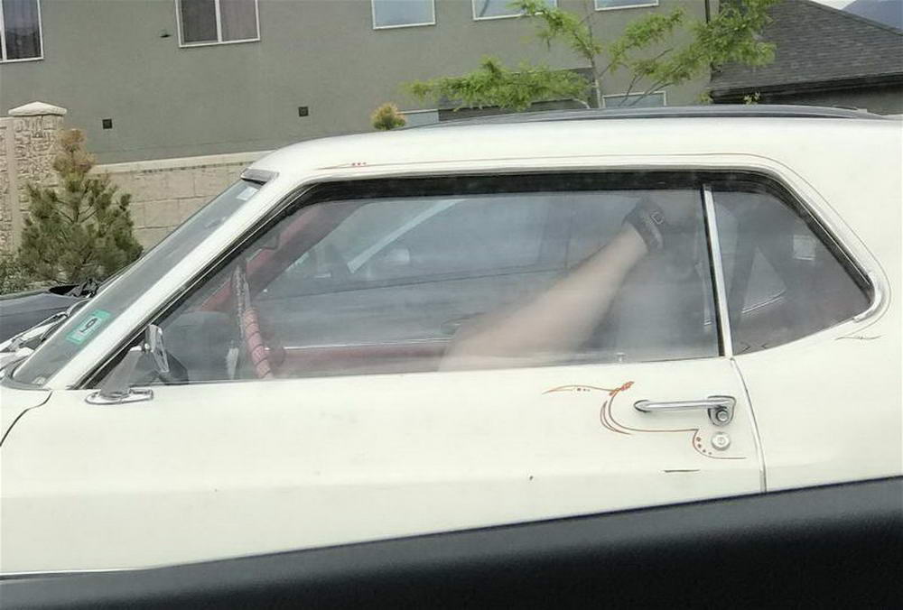 wtf images - mysterious legs upside down in car