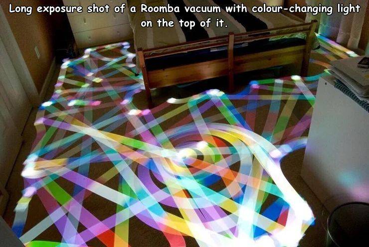 roomba art - Long exposure shot of a Roomba vacuum with colourchanging light on the top of it.