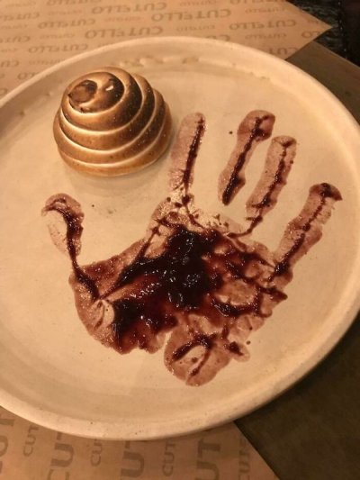 "A handful of jam served on a plate at an upscale restaurant."
