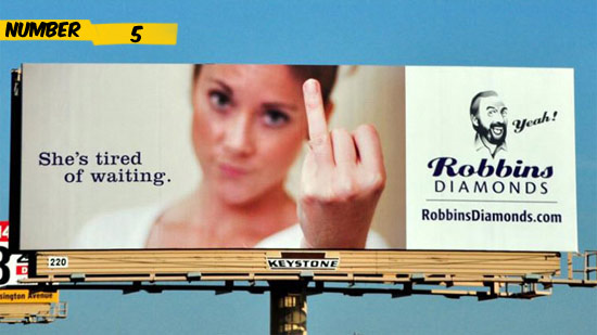 From far away it looks like the woman from Robbins Diamonds ad is giving you the finger, but at second glance you will see that she is showing her naked ring finger with the charming slogan Shes tired of waiting.