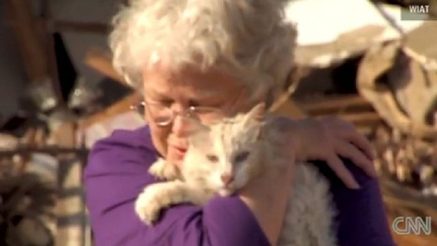 Time for something happy! Here's a picture of a woman who was miraculously reunited with her cat after a tornado.