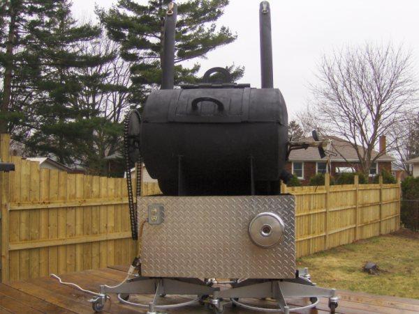 Super cool Canadian BBQ. This is not a smoker but an industrial size Rotisserie. Stacks on top and back. It has a kick stand and Harley air cleaner. Checkerplate bottom, all made from free items found or traded. Rear firebox. Chain Drive with gear reduction. WORKS LIKE A CHAMPION! 