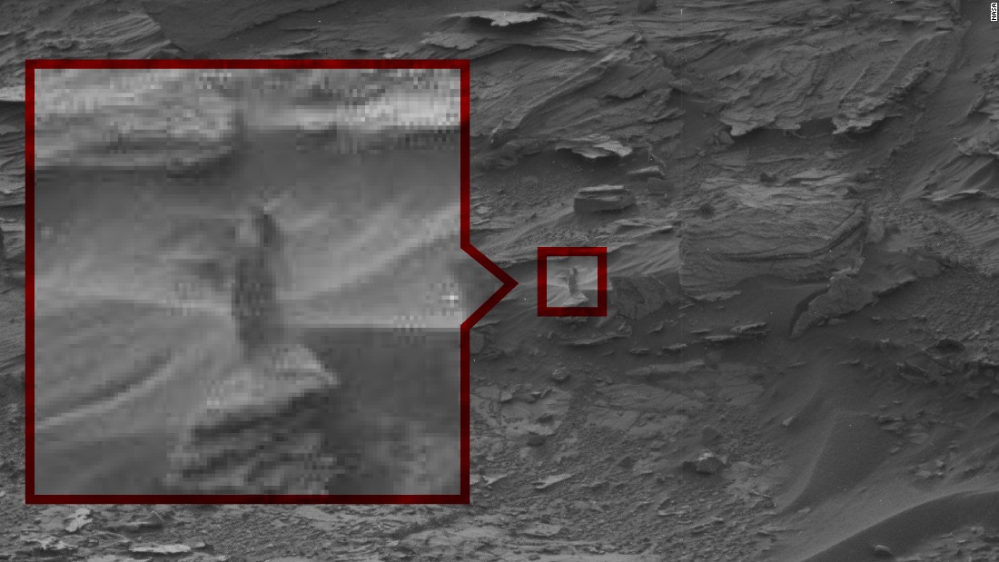 This ghostly woman appears to be looking down at the Curiosity rover. NASA says it's probably just a shape made by sand drifts.  