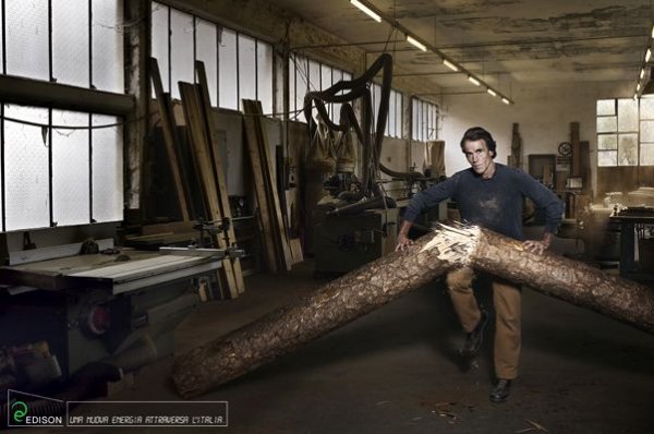 man next to a tree trunk that is cut in half
