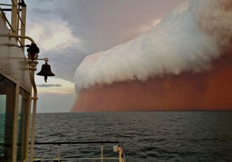 Captured in Australia in 2013, what appears as a tall red wave is actually an inbound dust storm.  