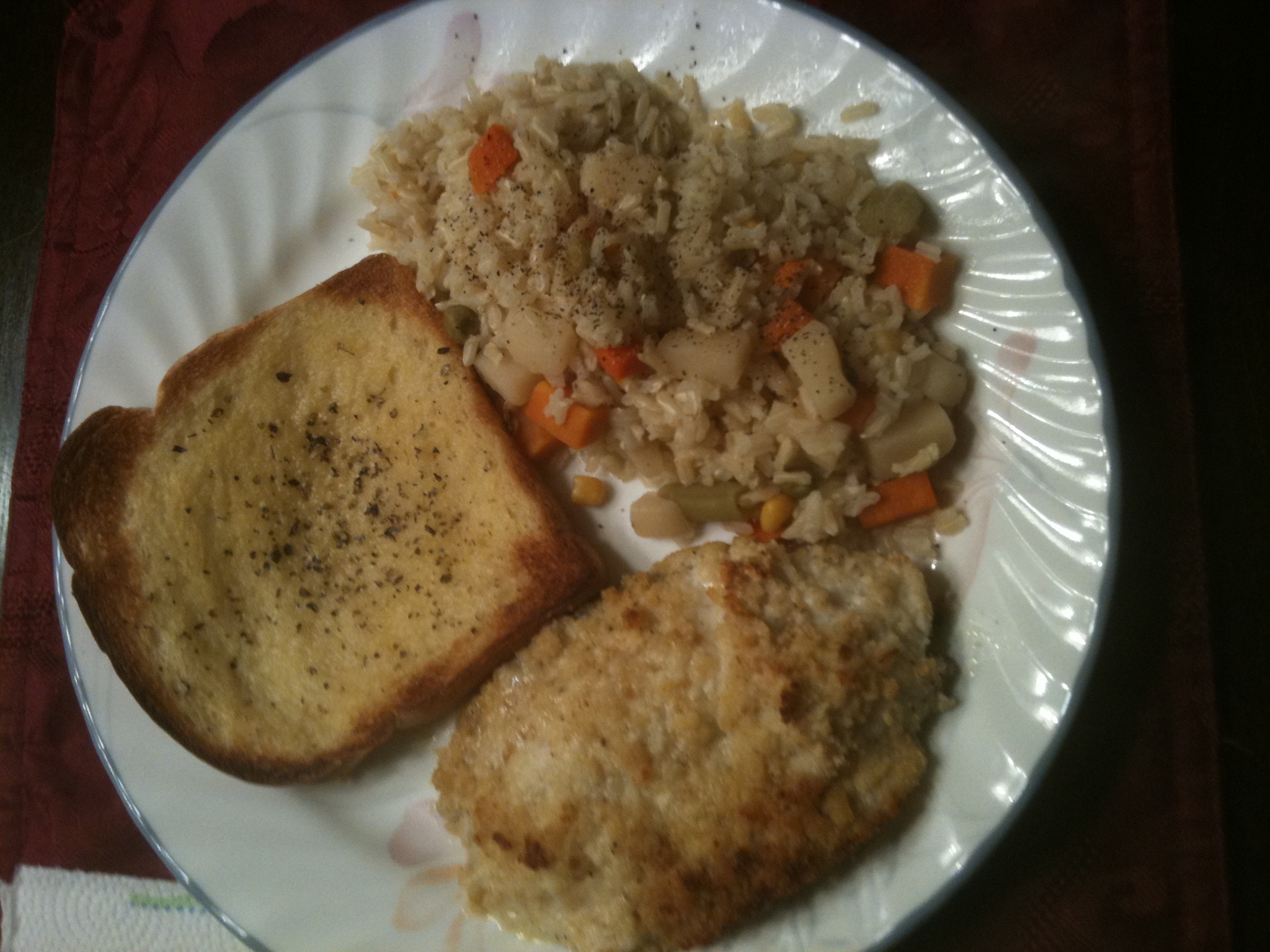 Oven Crusted Talapia, Rice Pilaf, Garlic Bread. 
