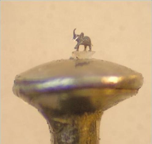 Elephant,on a Grain of Sand atop the head of a pin