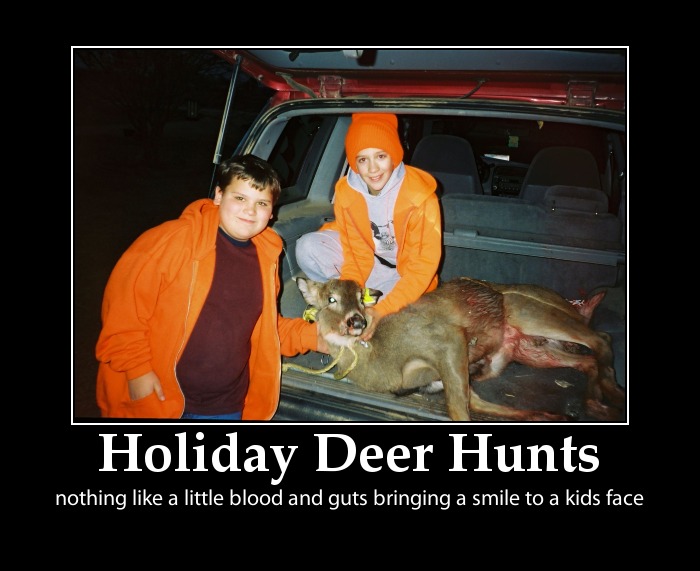 2 young boys posing with a dead deer at Thanksgiving time..