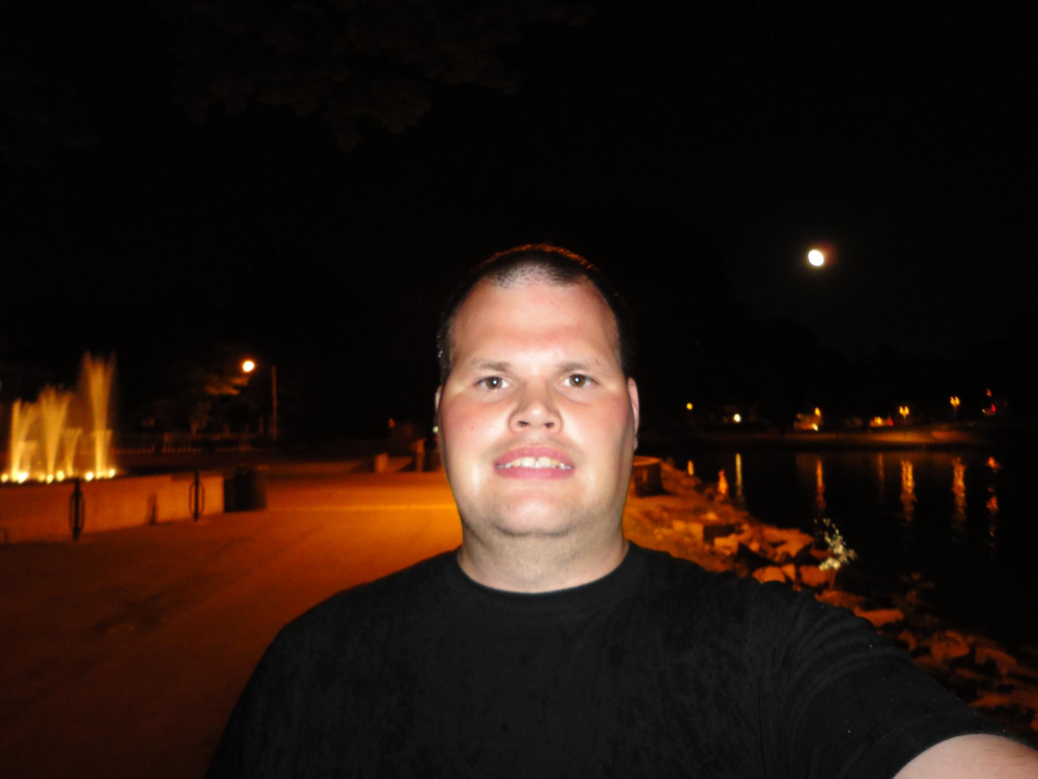 Frankie MacDonald is Walking down the Park Up By the Water fountain during at night.
