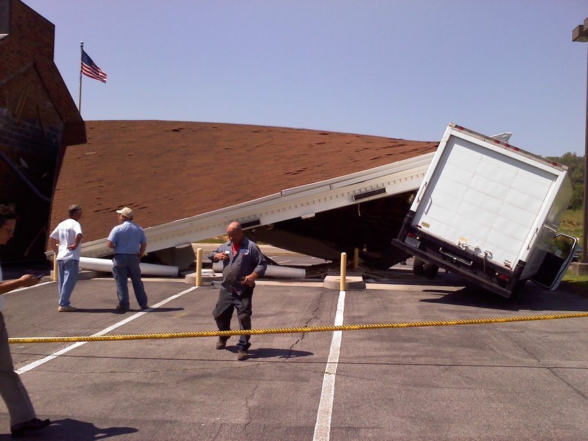 Truck driver hits bank canopy