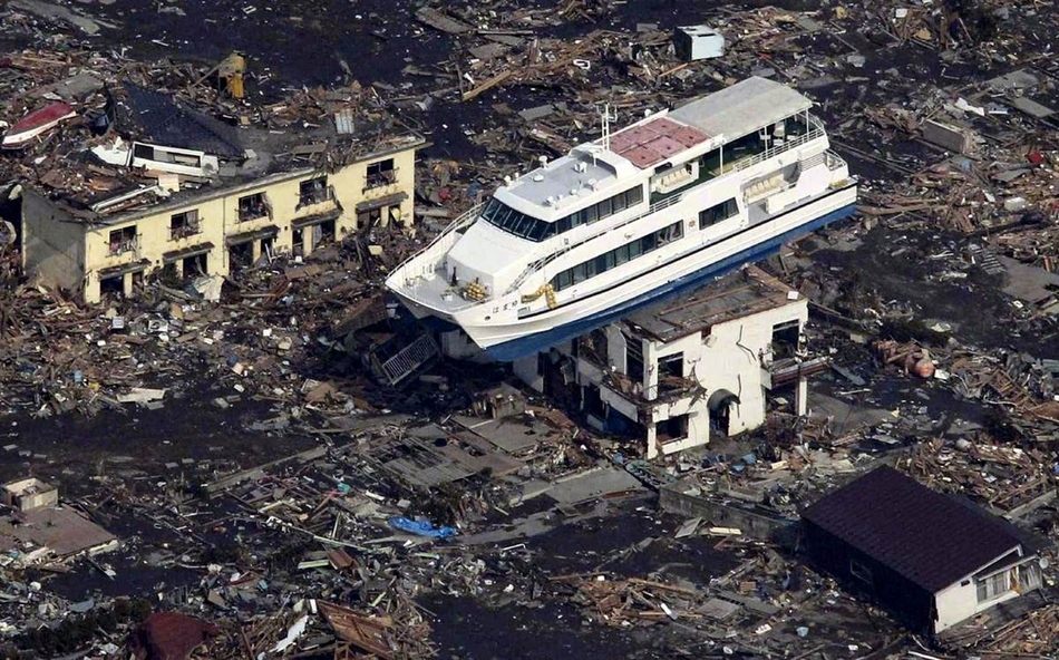 Boat balanced itself on a two story house during the tsunami in Japan.