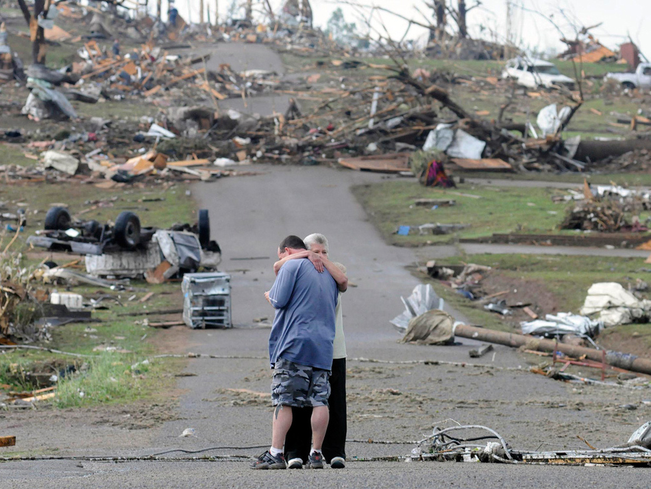 A mother comforts her son in Concord, Alabama, near his house which was completely destroyed by a tornado in April.