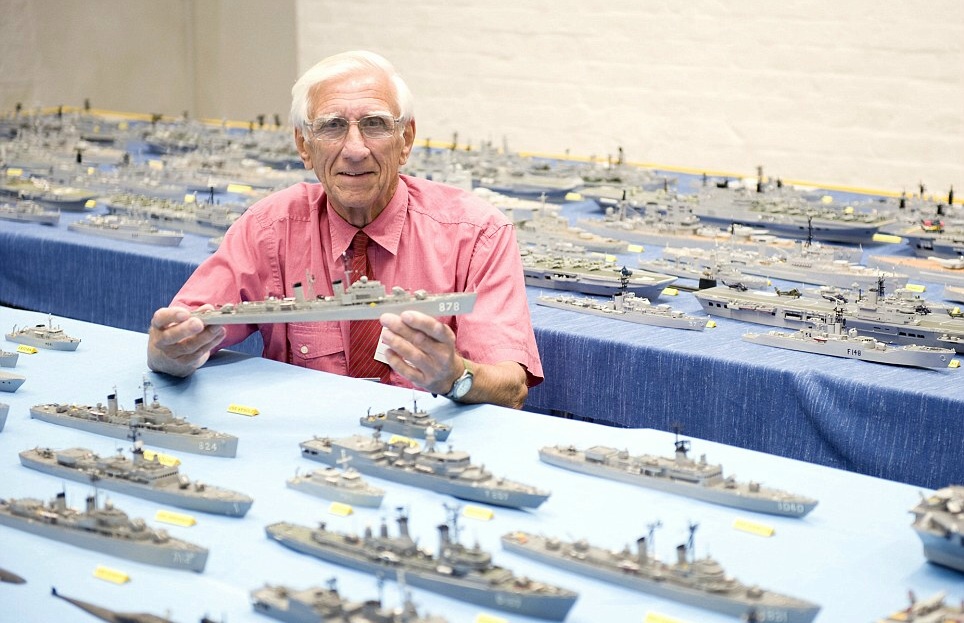 Philip Warren surrounded by his fleet of warships made entirely out of matchsticks and matchbox wood