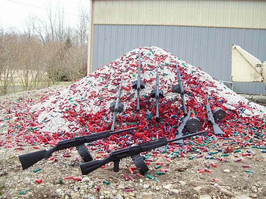Saiga shotguns sitting on a mountain of spent shells