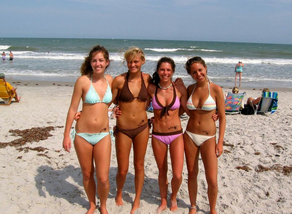 Four hot chicks in bikinis sporting similar tattoos