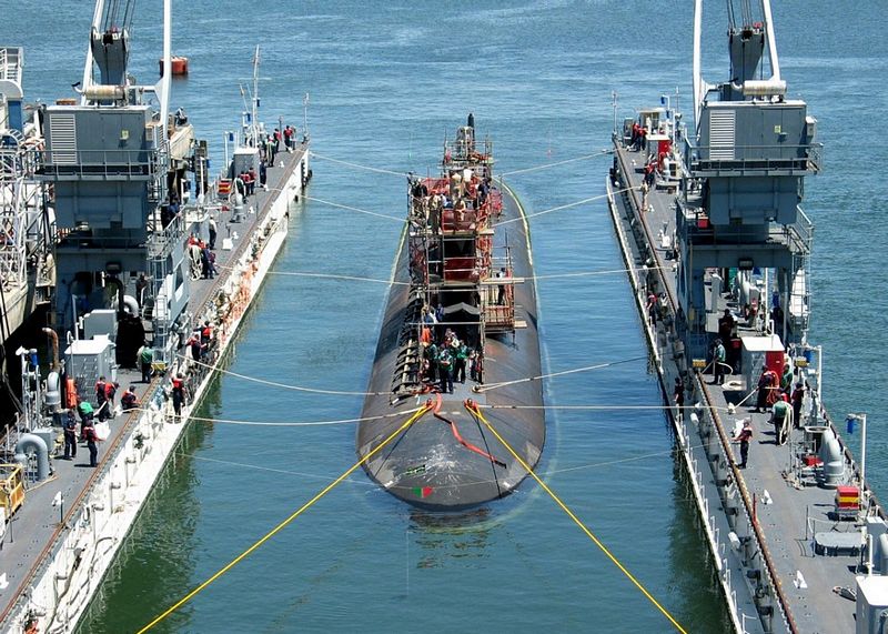 Submarine tied off to dock