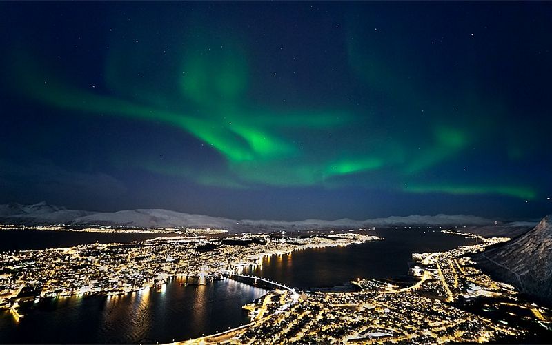 Northern lights over beautiful cityscape