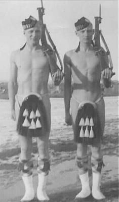 Two Calgary Highlanders stand by the banks of the Bow River, Calgary, before departing for the war. They are humorously depicting Canada’s equipment shortages at the beginning of the war… too many volunteers, not enough uniforms!