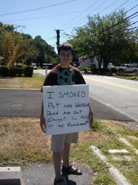 This is a picture of a kid who got busted smoking pot and watching pr0n. And because getting caught by your parents WHILE YOU'RE HIGH AND WITH YOUR WIENER IN YOUR HAND isn't bad enough, they made him make this sign and stand by the road. God, you poor bastard.