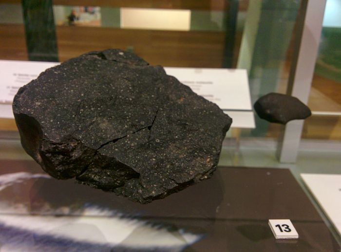 This is a fragment from the Murchison Meteorite which landed in Victoria, Australia in 1969. It has beed dated at nearly 4.95 billion years old  nearly 500 million years older than the age of the Earth