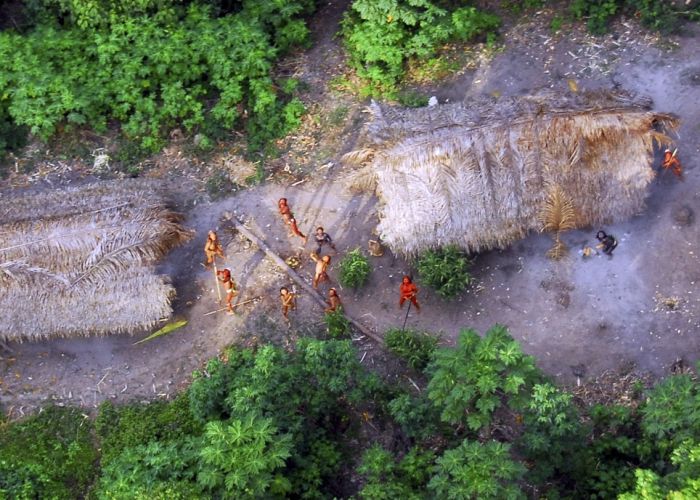 Incredible pictures of one of Earths last uncontacted tribes firing bows and arrows