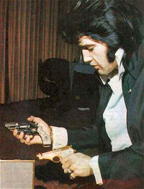 Elvis Presley and some of his guns