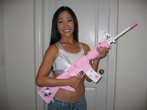 A hot pink "Hello Kittie" edition AR-15 rifle.
And the girl isn't that bad looking either!