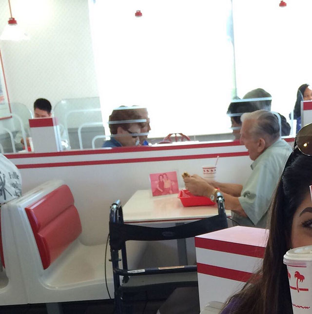 Old man eating by himself at In N Out with a picture of his wife