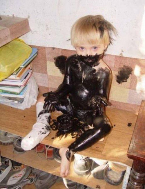 scary kid kid covered in black paint