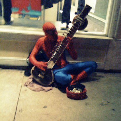 I guess Spiderman doesn't get payed for saving the world, so he has to play the Sitar to pay the bills.